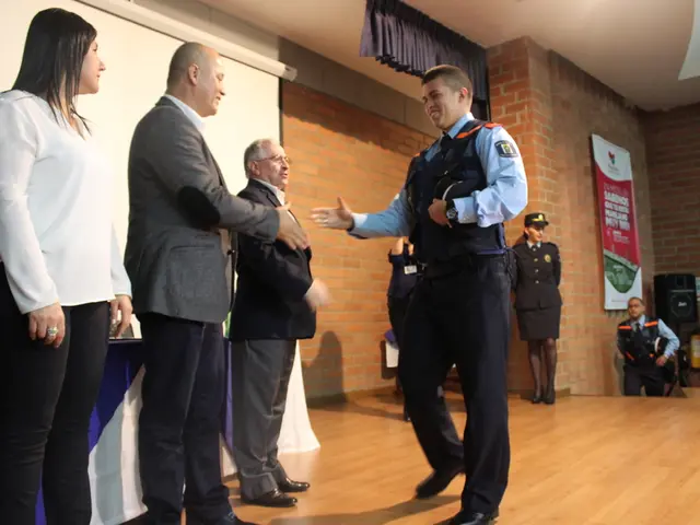 In this image we can see a group of people standing on the stage. One person wearing the uniform is...