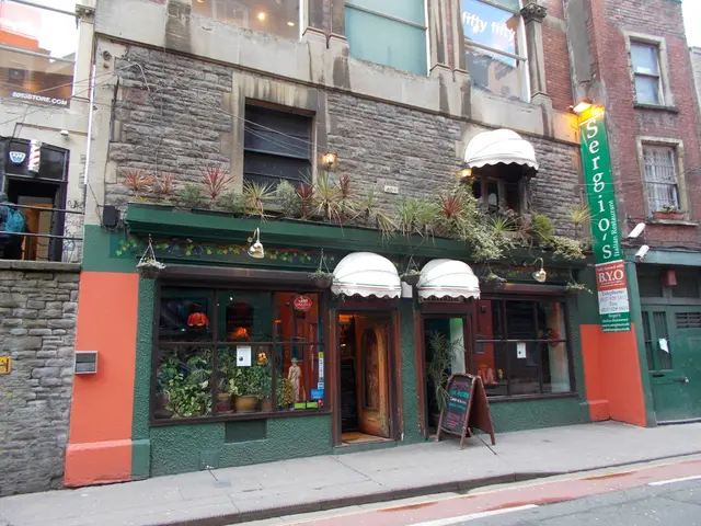 At the bottom, we see the road. In the middle, we see a board in black color with some text...