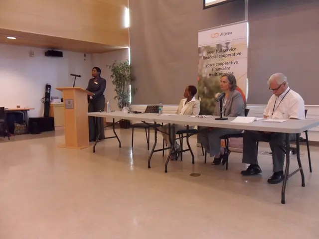 In this Image I see 3 women and a man in which these 3 are sitting and this woman is near to the...