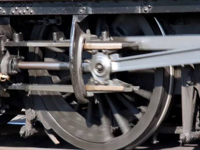 In the picture there is a wheel of a train present.
