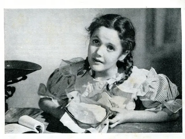 In this picture there is a girl who is sitting near to the table. On the table we can see book,...