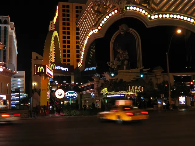 As we can see in the image there are buildings, traffic signals, street lamp, statue, banners,...