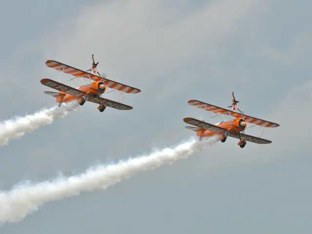 In the image there are two aircraft flying in the sky, they are leaving smoke from behind.