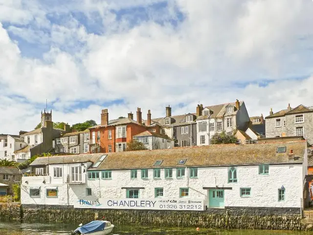 In this image we can see a motor boat on the river, on the other side of the river there are...