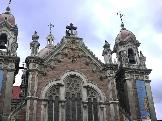 In the image there is building with walls, pillars, sculptures, glasses and designs on it. And also...