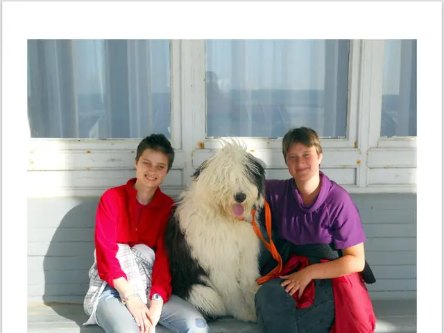 Here we can see a two woman on the either side of a dog.