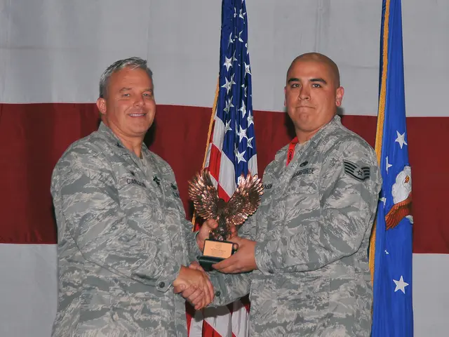 In this image these two persons standing and holding a award in there hands, in the background...