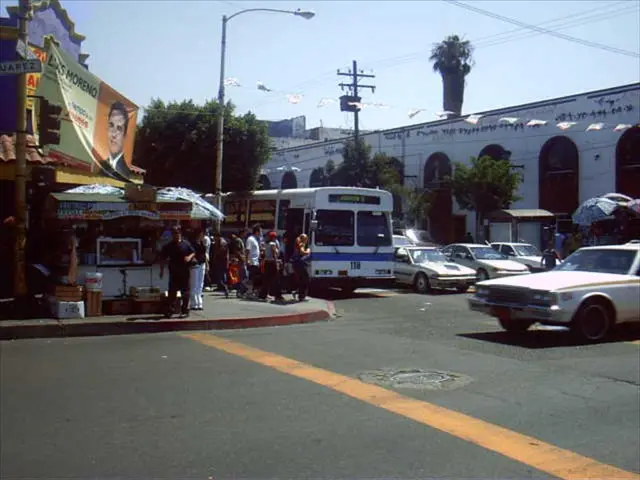 This image is clicked on the roads. There are many vehicles in this image. On the left, we can see...