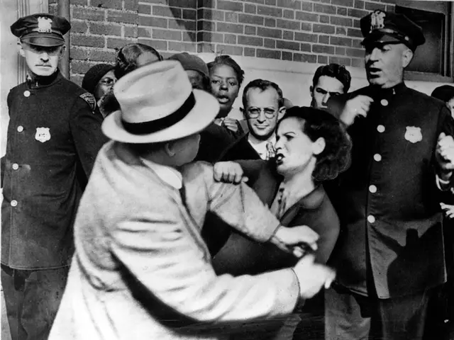 This is a black and white and here we can see two people fighting and in the background, there are...