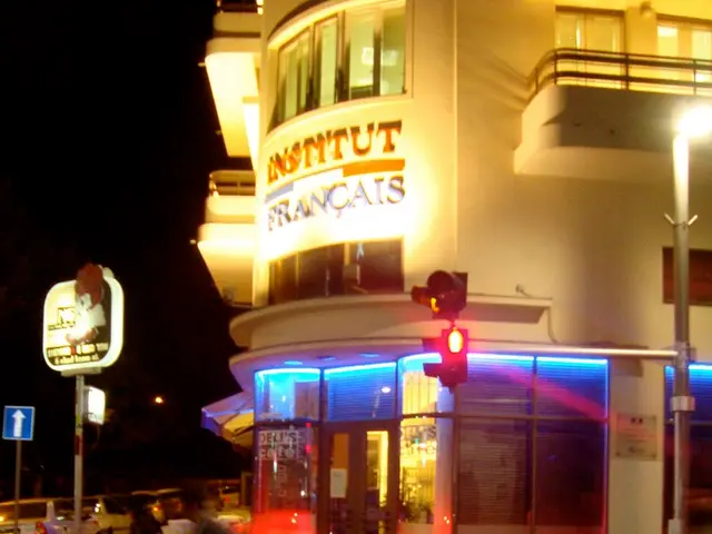 In this image there is a building towards the right of the image, there is text on the building,...