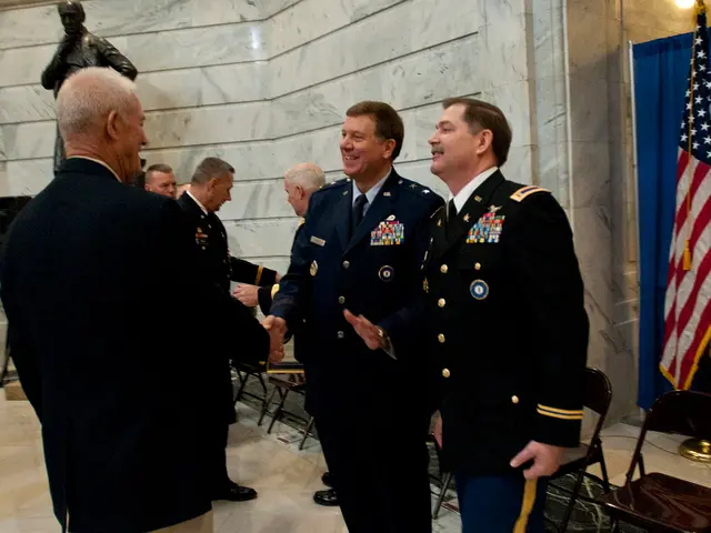 In this image there are people standing and shaking their hands, behind the people there are...