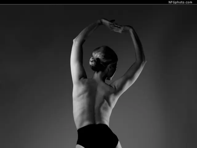 It is the black and white image of a girl who is standing on the floor without the clothes.