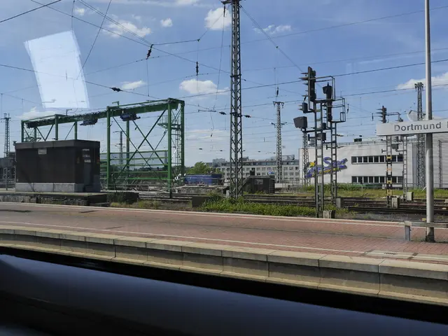 In this picture I can observe railway platform. There are some wires in the middle of the picture....