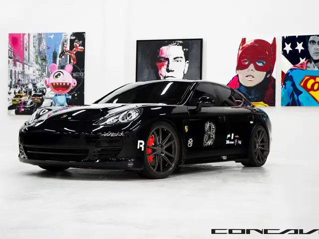 In this picture there is a black color Nissan sports car. Behind there are some cartoon posters and...