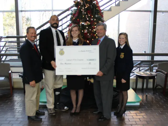 In the image we can see few persons were standing and holding certificate. In the background we can...