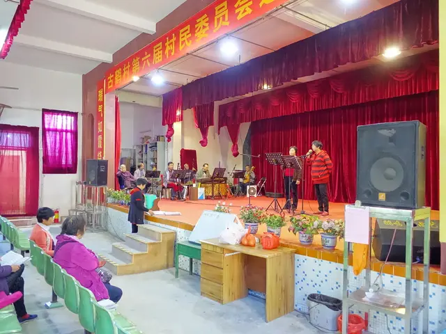 This picture shows a stage on which two people were standing and singing. There is a music band in...