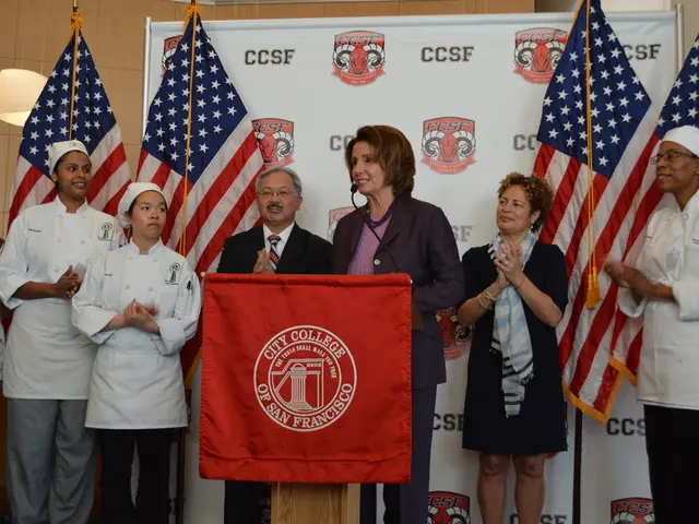 In this picture we can see some people and a woman standing at the podium, smiling and in front of...