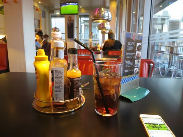 The picture is clicked in a restaurant where food eatables are kept on top of a table and there is...