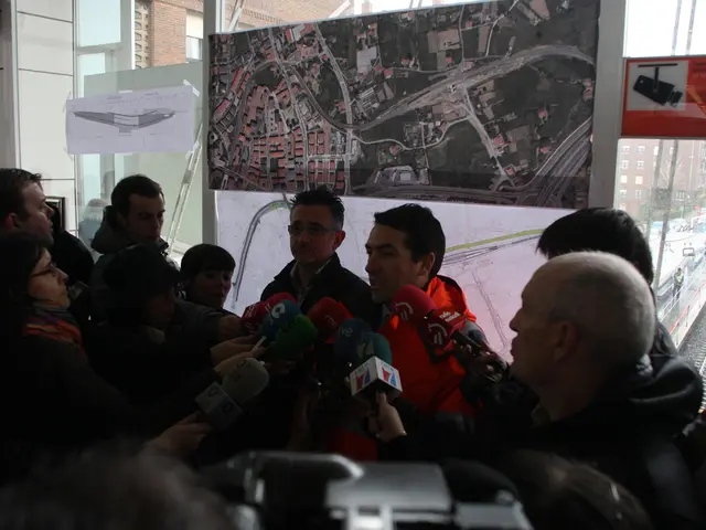 In this image there are group of persons standing, the persons are holding a microphone, there is a...