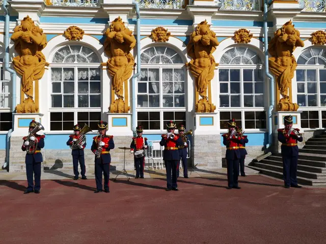 In this image there are some persons standing and playing an instruments in middle of this image....