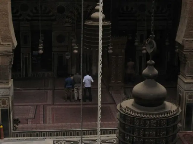 In the picture I can see inside view of a cathedral church and I can see some persons standing.