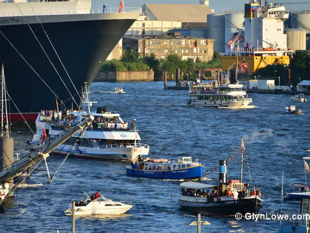 this picture shows buildings, ocean and few ships and feel boats ,carrying people on them