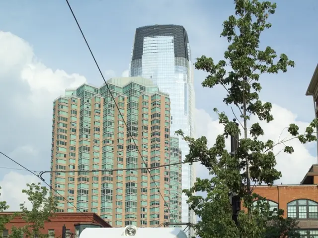 In this picture we can see a train on the railway track and on top of the train there are electric...