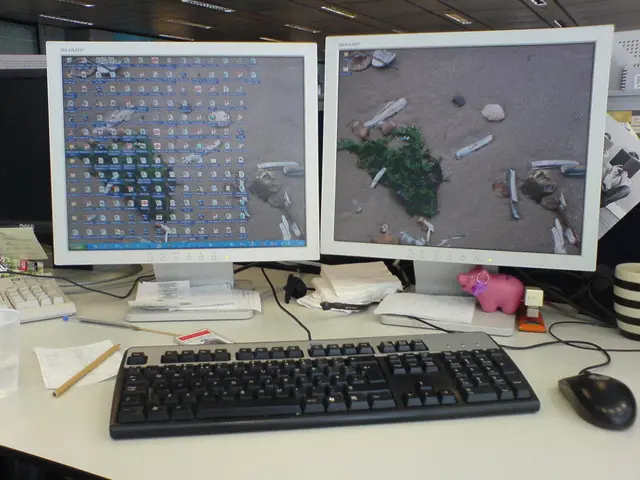 In the picture we can see two computer systems on the table along with the keyboard and mouse,on...