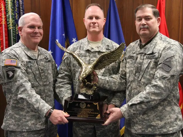 In this image I can see three men are standing in the front and I can see all of them are holding...