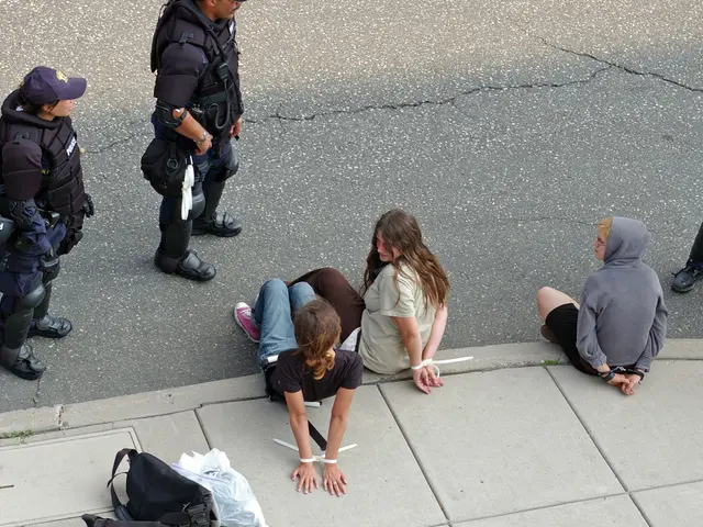 In this image there is a road truncated towards the top of the image, there are persons on the...