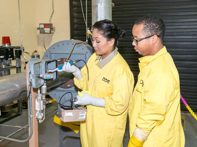 In this image ,I can see there are two people standing and operating some machine and at the back...