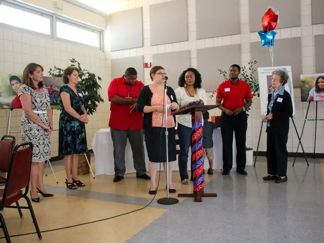 There are few people standing. Here is the woman standing speaking on the mike. This is the podium...