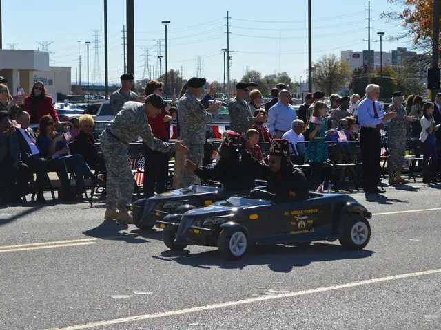 In this image there are group of persons present on the track and there are two persons who are...