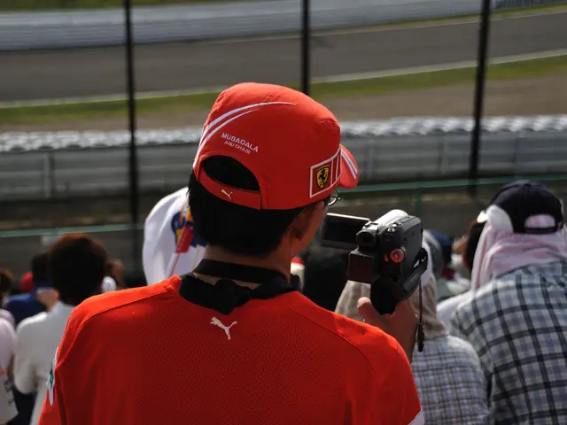 This picture shows few people and we see a man holding a video camera in his hand and we see a...