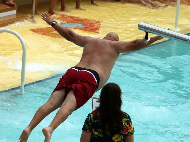 A man is jumping into the water and at the bottom we can see a woman and there are papers to a pad....