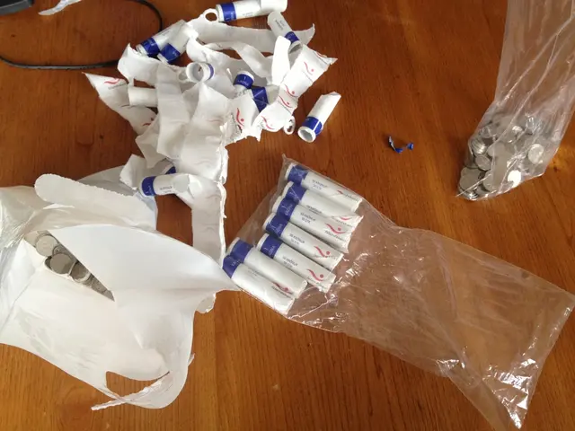 There are some white color objects and some coins are kept on a wooden surface as we can see in the...