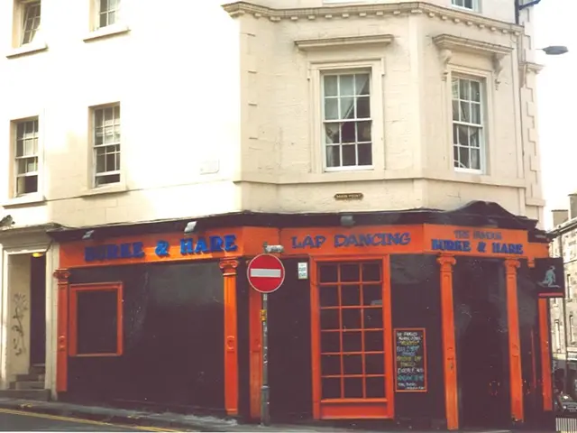 In this image there is a building for that building there are windows and doors, on that building...