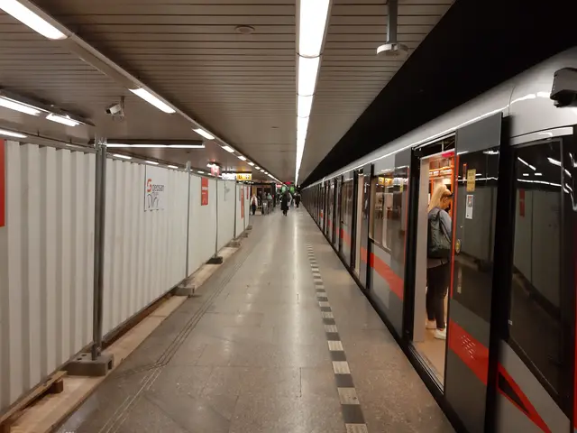 The image shows a subway train pulling into a station next to a platform, with a group of people...