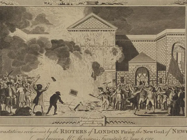 The image shows a group of people standing in front of a building engulfed in flames, with smoke...