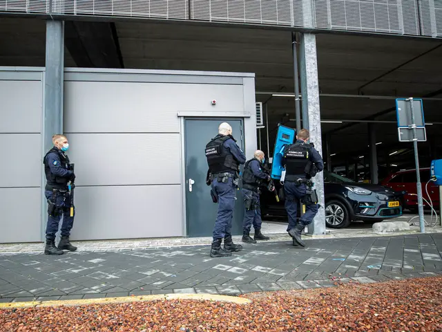 The image shows a group of police officers standing in front of a building with a door, surrounded...