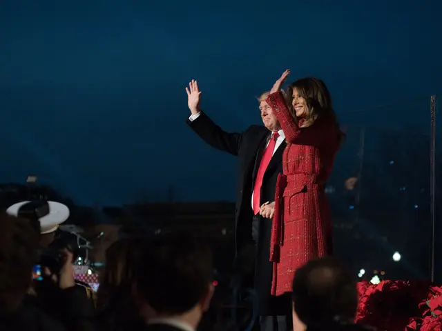 The image shows President Donald Trump and First Lady Melania Trump waving to the crowd as they...