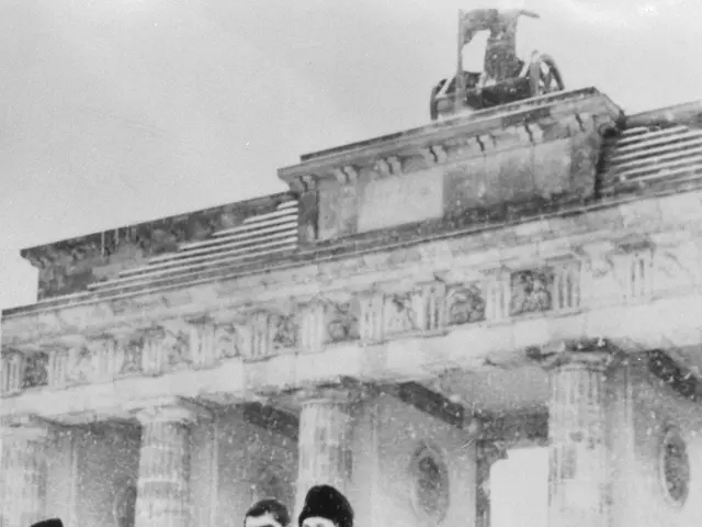 The image shows a group of men standing next to each other in front of the Brandenburg Gate in...