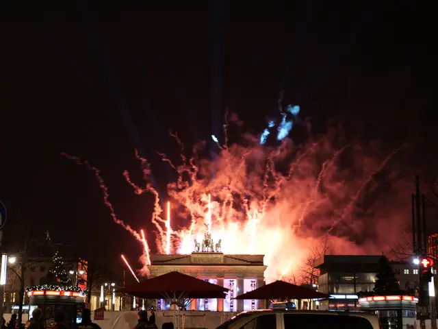 The image shows a car parked in front of the Brandenburg Gate in Berlin, Germany, illuminated by...