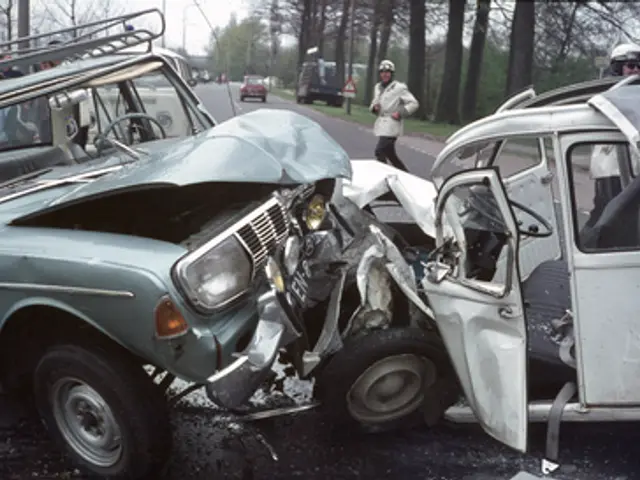 The image shows a car that has been involved in a crash on the side of the road, surrounded by...