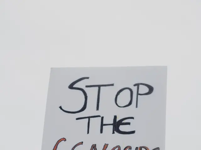 The image shows a group of people holding signs that read "Stop the Genocide of the Kurds" against...