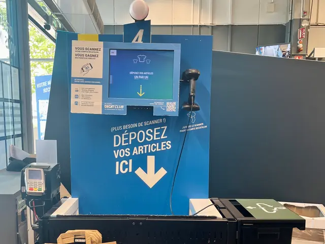 The image shows a large machine sitting in the middle of a room, surrounded by dustbins on the...