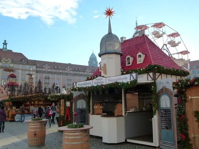 The image shows a bustling Christmas market in Nuremberg, Germany. There are many people gathered...