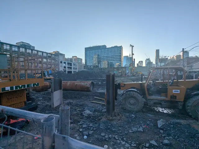 The image shows a construction site with a bulldozer parked in the middle of it, surrounded by...