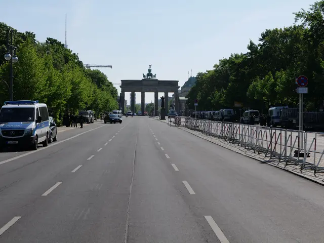 The image shows a police van parked on the side of a road in front of the Brandenburg Gate in...