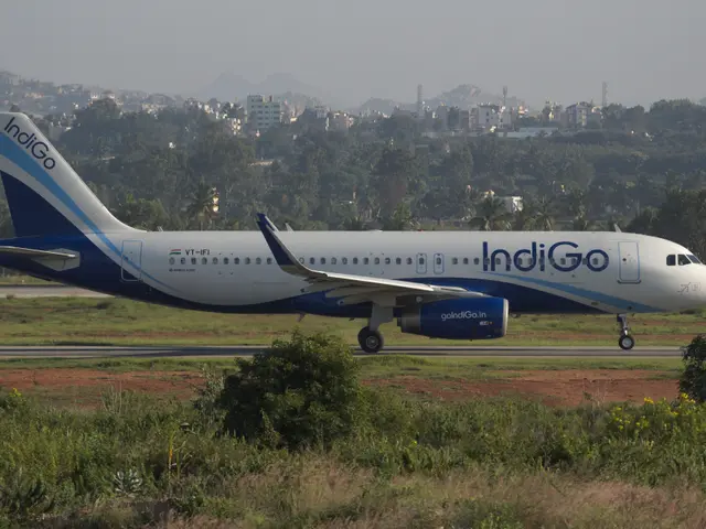 The image shows an Indigo Airlines Airbus A320-200 on the runway at Mumbai Airport, surrounded by...